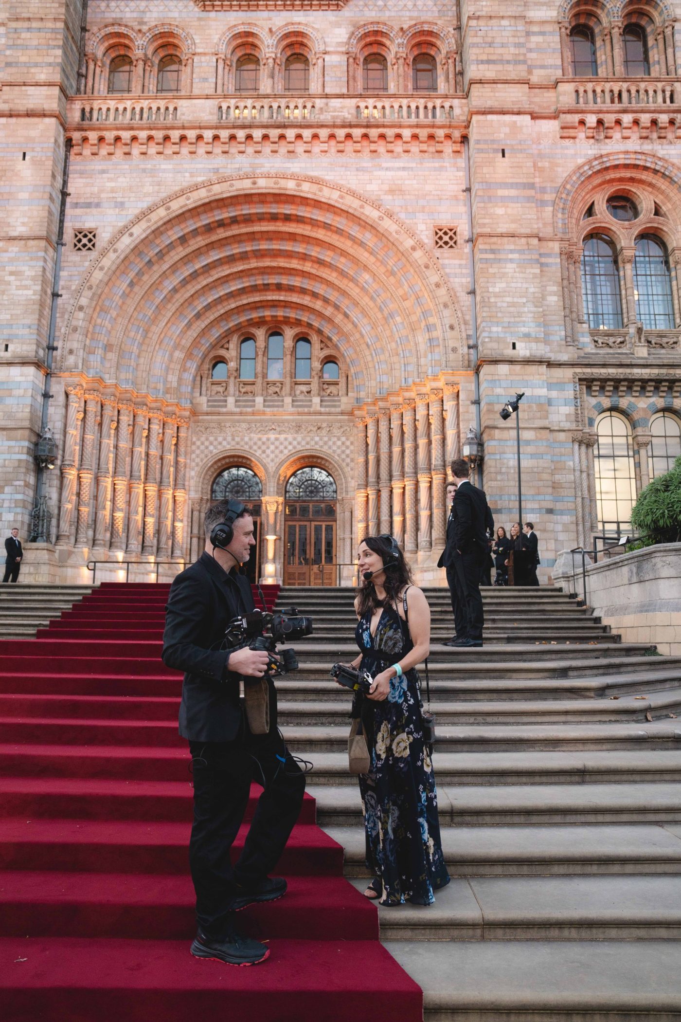 Emily Calderone producing on a red carpet with a camera operator